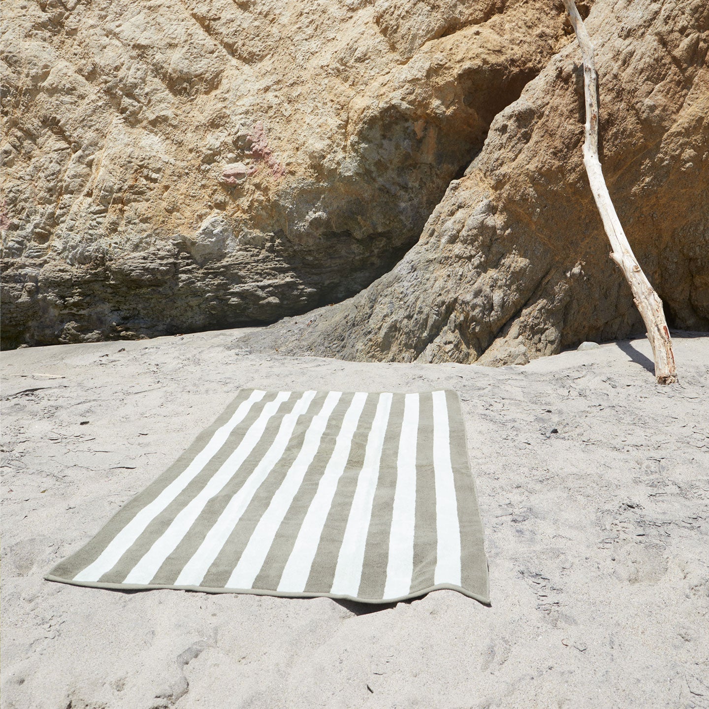 A stack of striped olive and sage terry towels in various sizes.