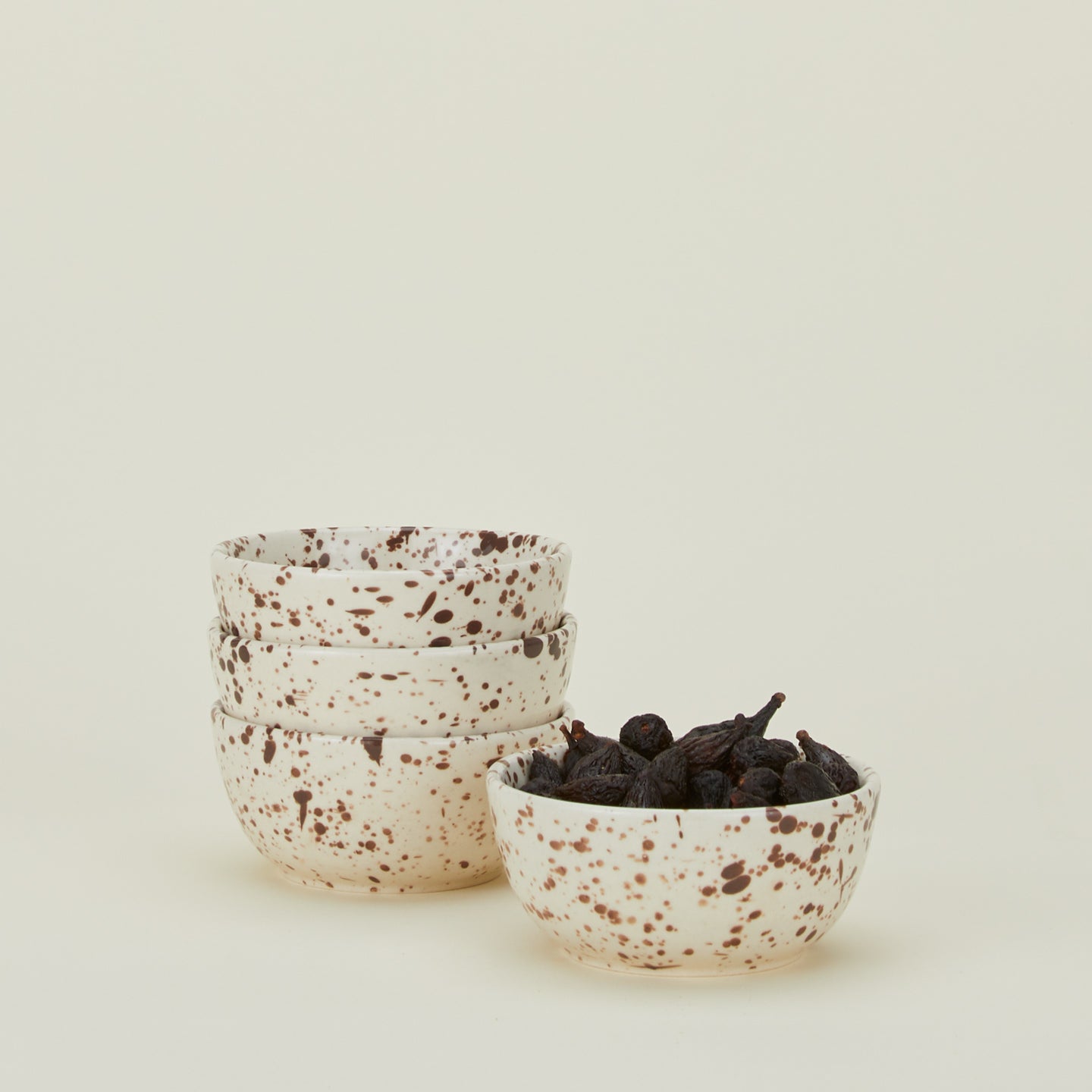 Set of four white bowls with cacao brown splatter glaze.