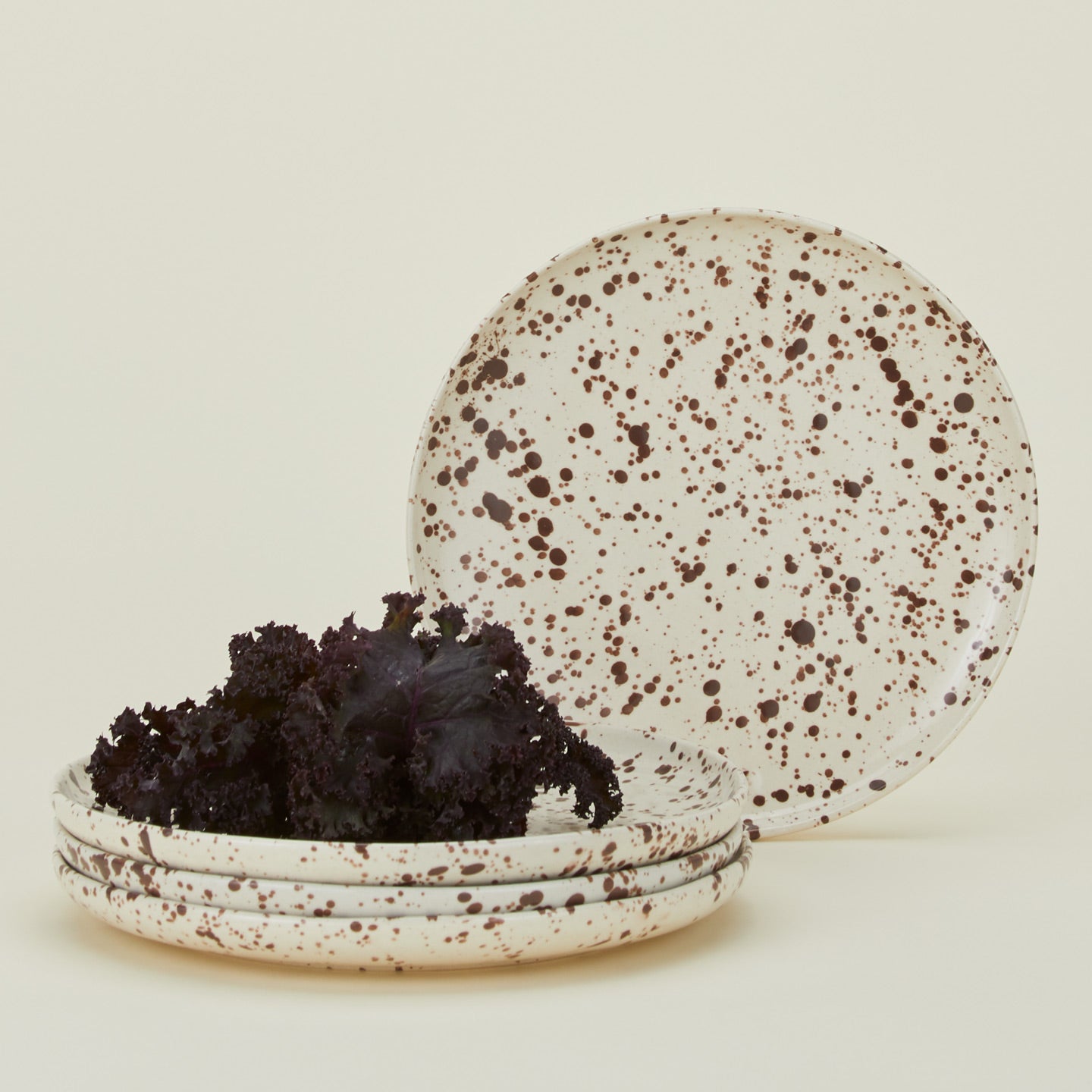 Set of four white plates with cacao brown splatter glaze.