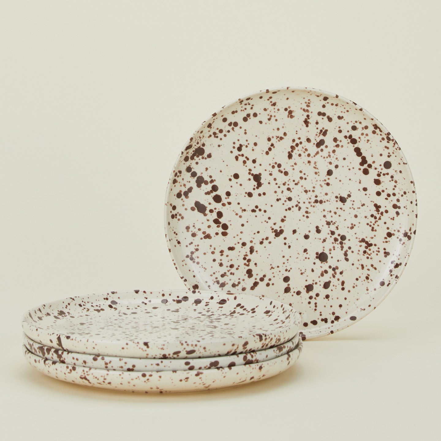 Set of four white plates with cacao brown splatter glaze.