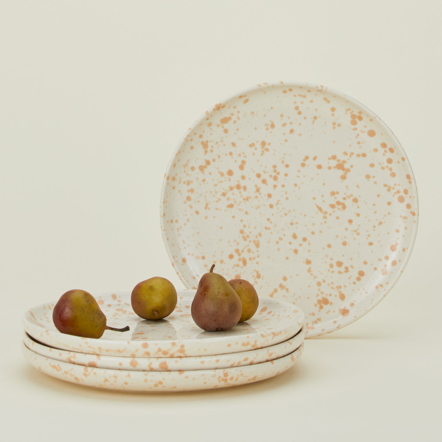 Set of four white plates with latte light brown splatter glaze.