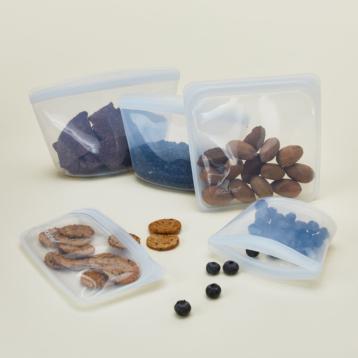 Silicone storage bags in various shapes and sizes with food.