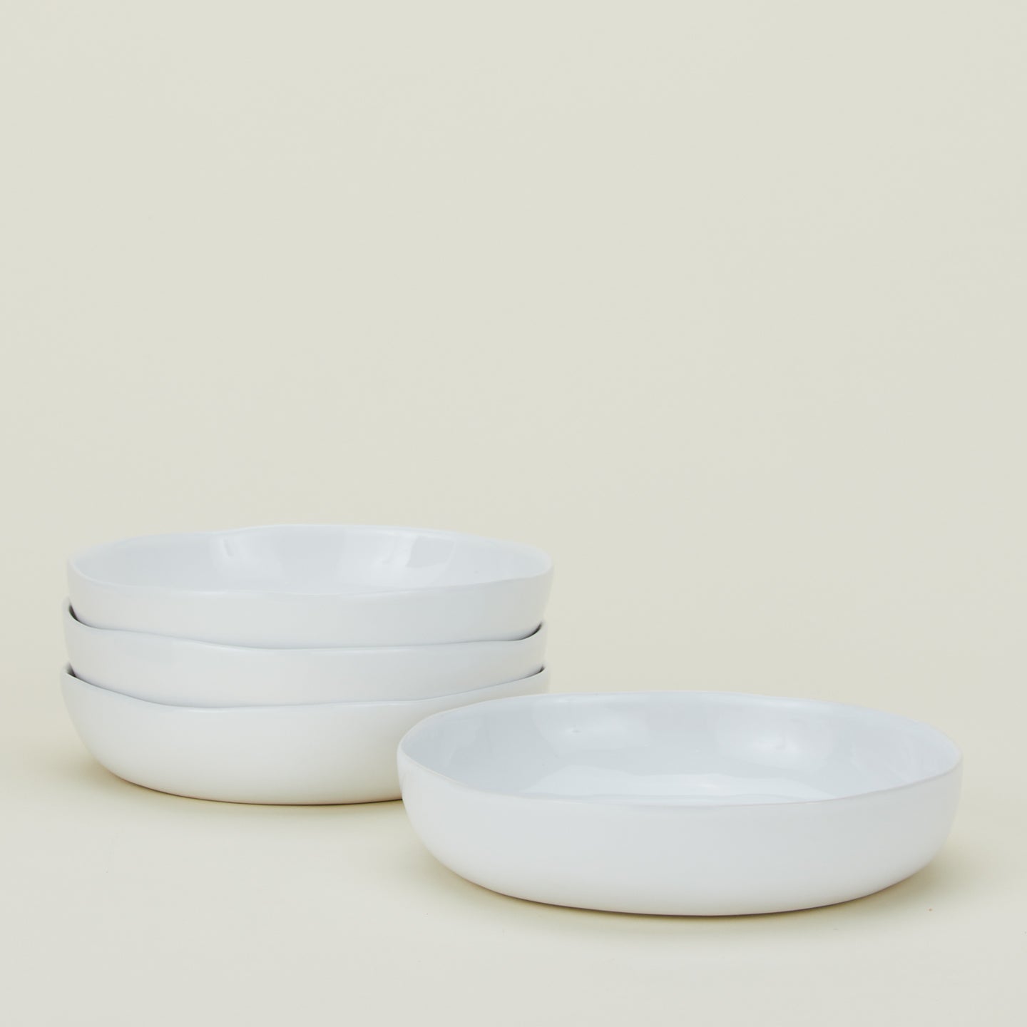 Four white Strata Low Bowls.