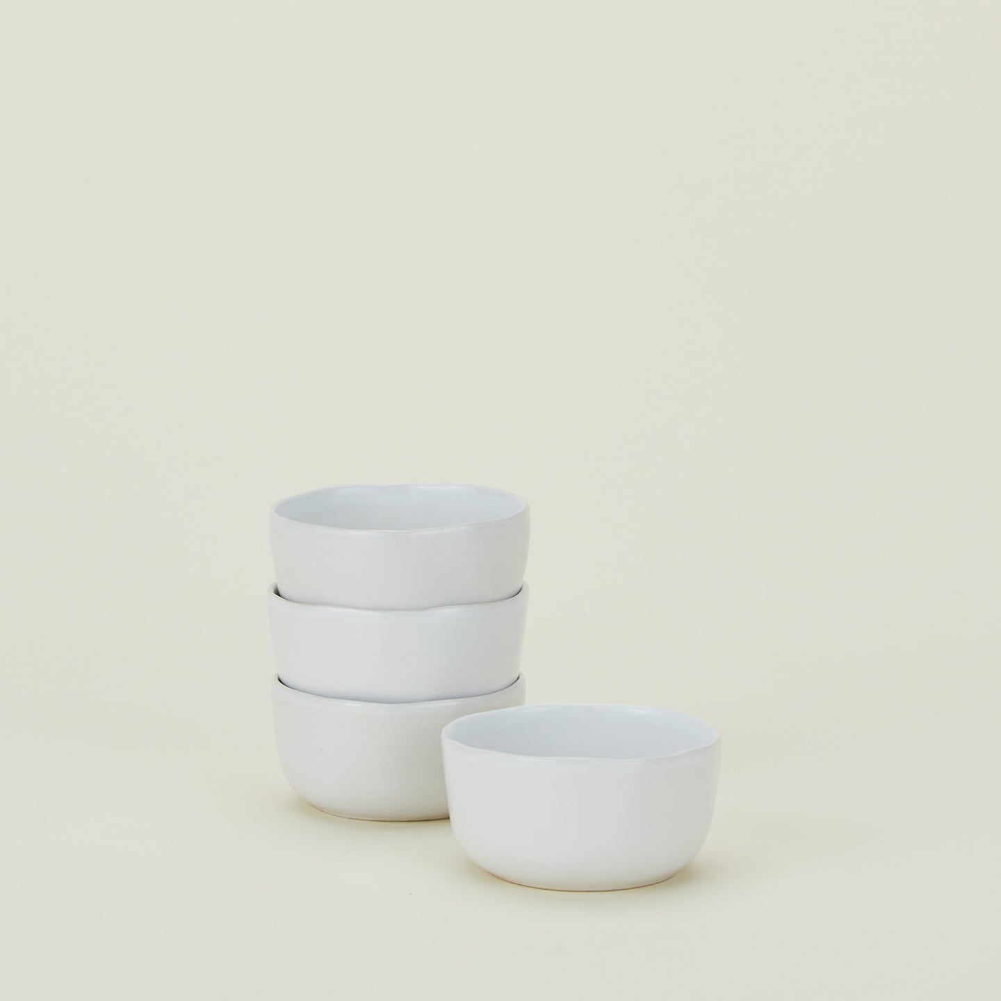 Four white Strata Small Bowls.