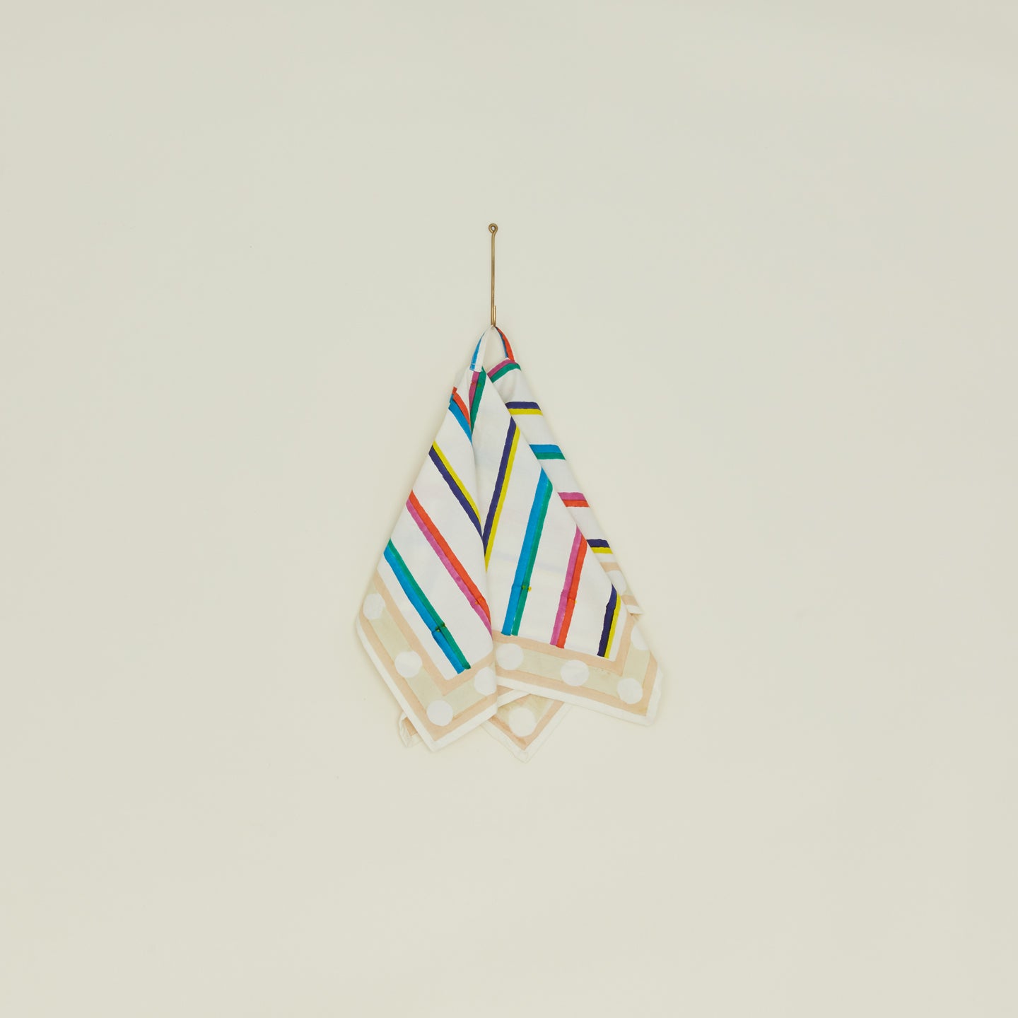 Block Printed Dish Cloth in Multi Stripe hanging from hook.