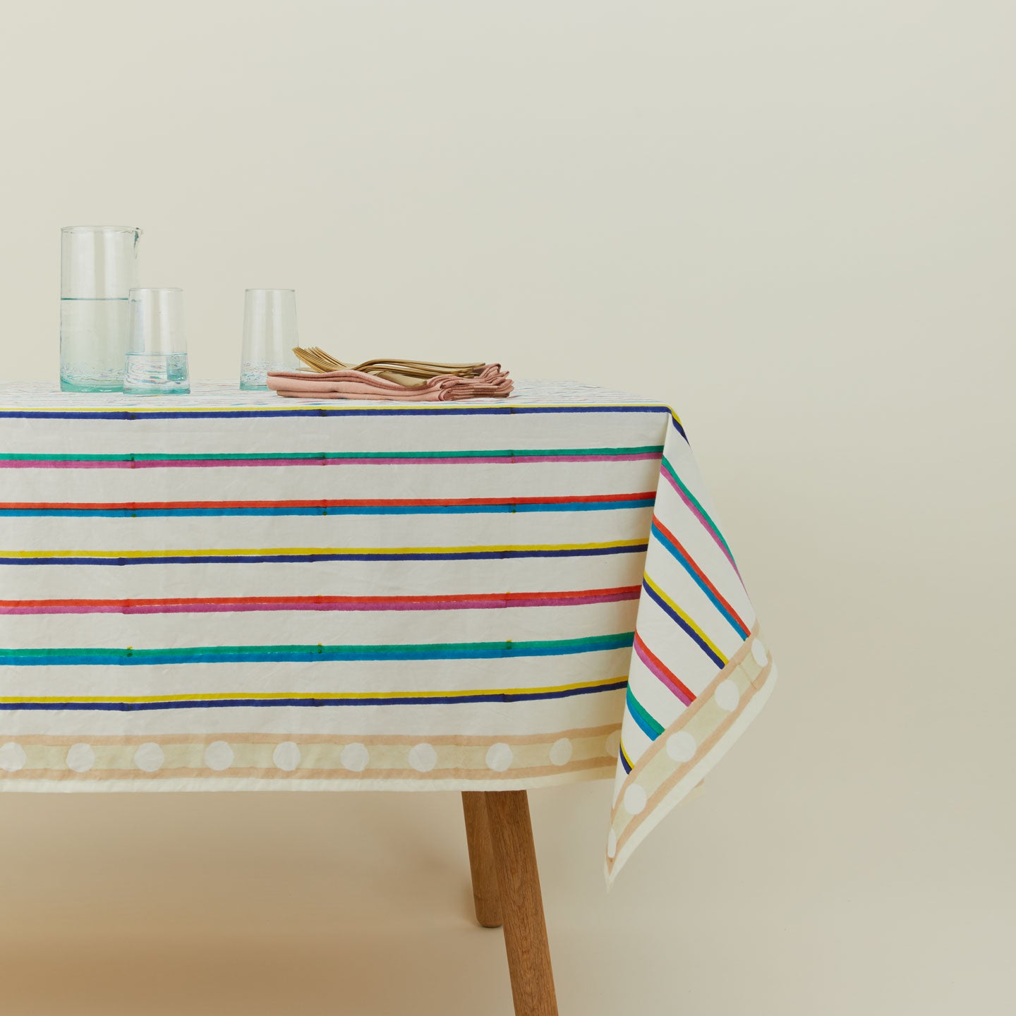 Block Printed Tablecloth in Multi Stripe on table.