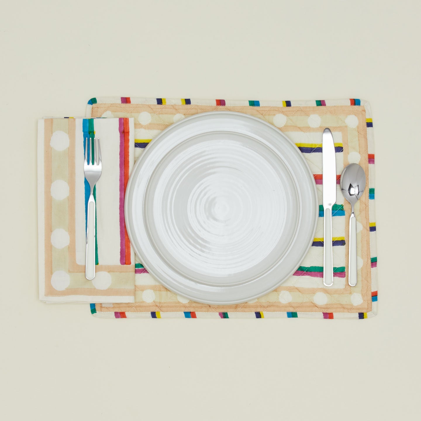 Place setting with Block Printed Quilted Placemat in Multi Stripe.