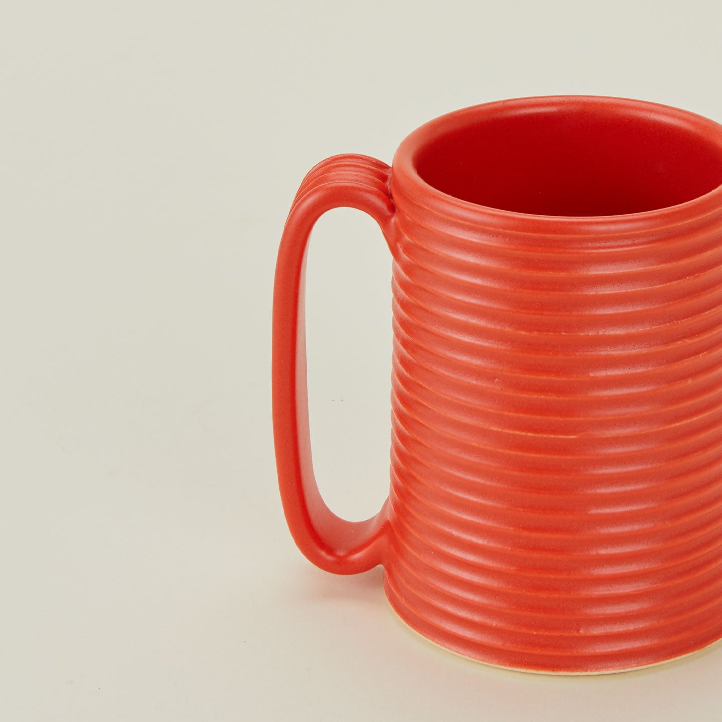 Close up of a Tall Ribbed Mug in Papaya.