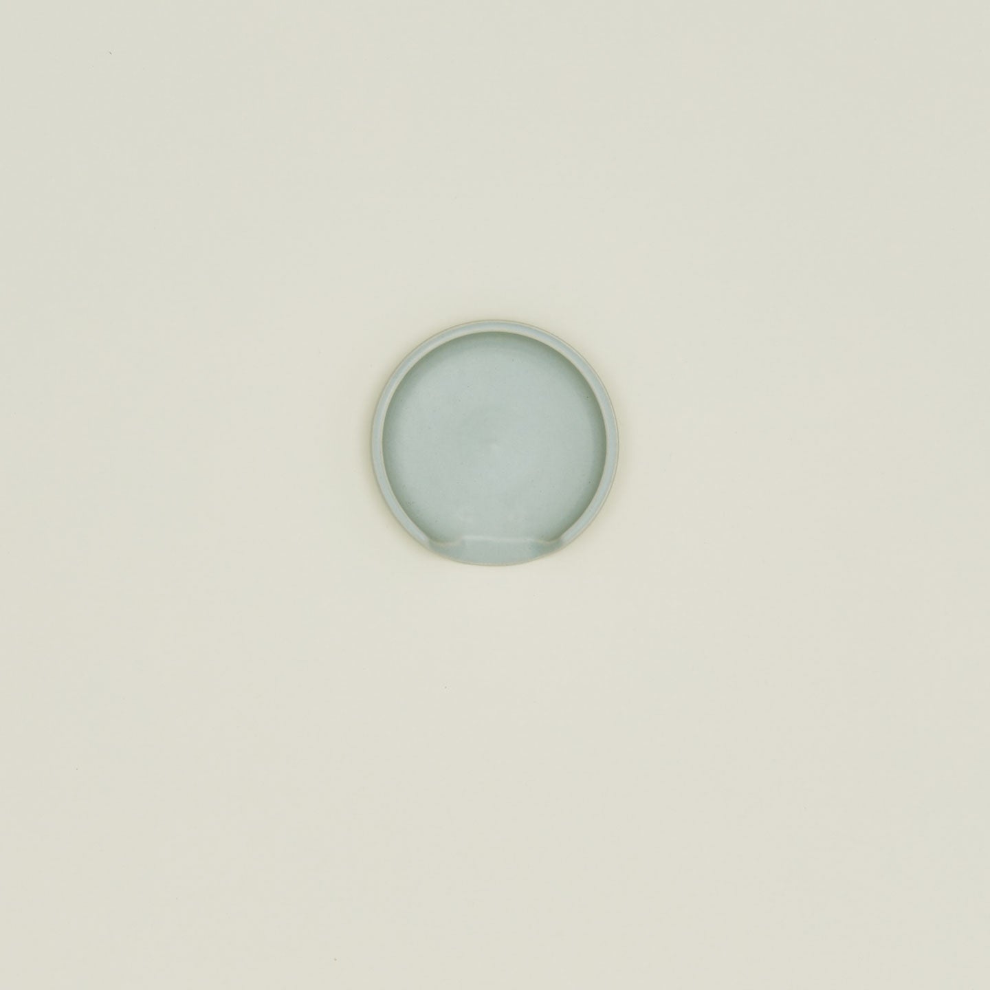 An overhead of a seafoam stoneware spoon rest.