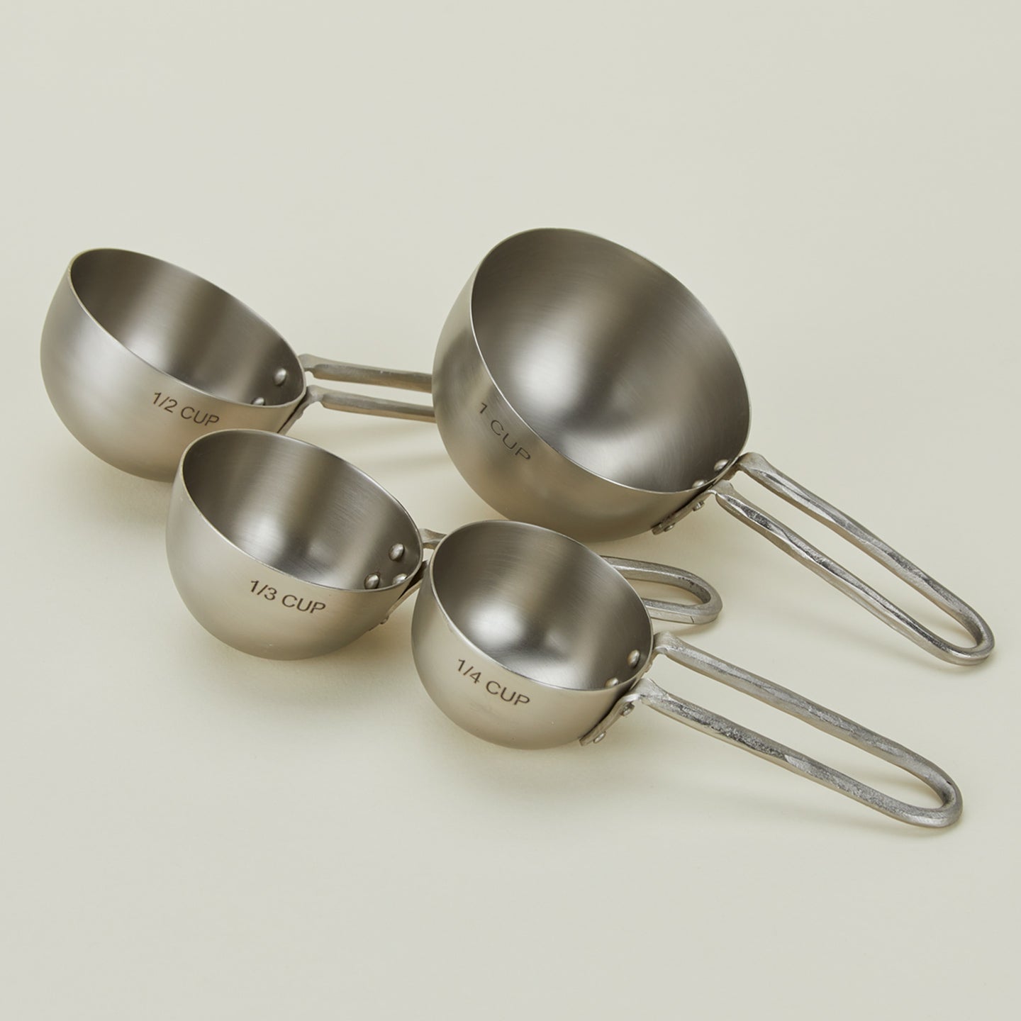 Close up view of forged pewter measuring cups