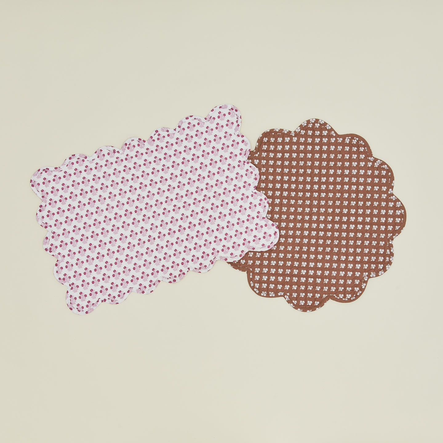 Two quilted placemats in various colors.