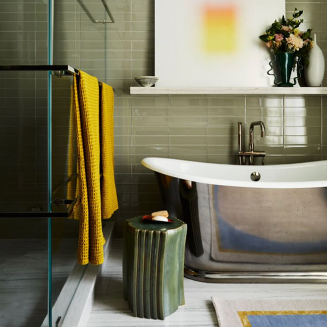 Bathroom with towels draped on shower curtain