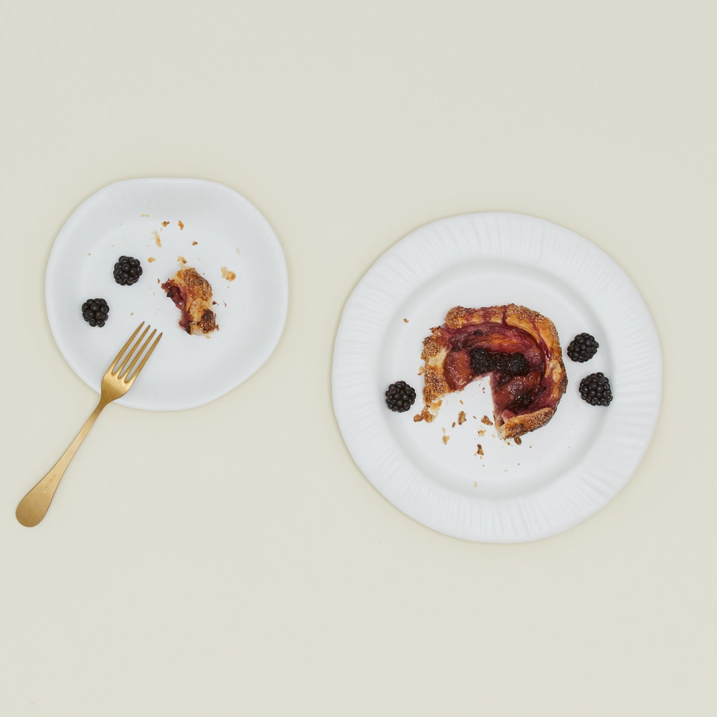 Two Porcelain Paper Plates in various sizes with berry tart and fork.