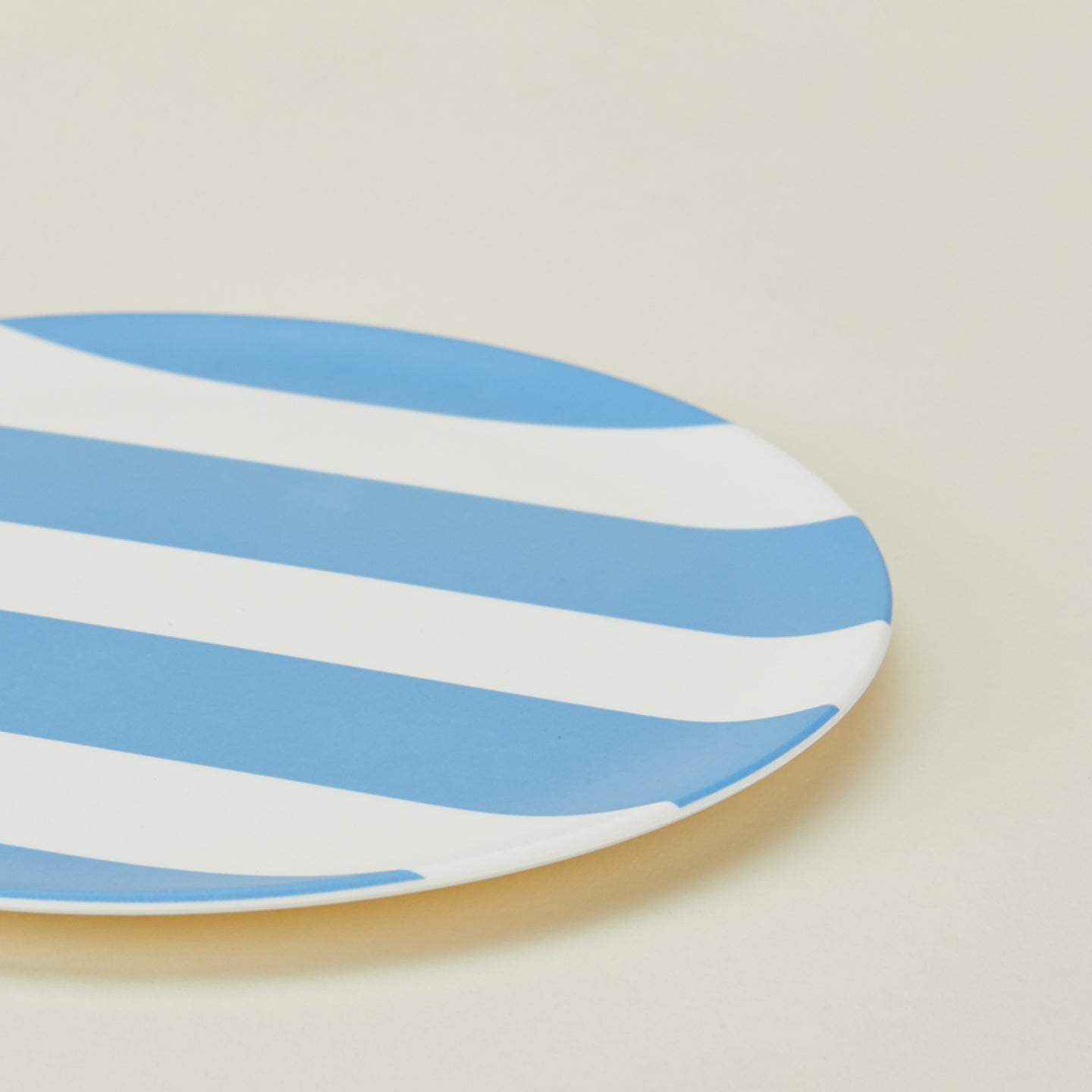 Close up of bamboo melamine side plate in Wide Blue Stripe.