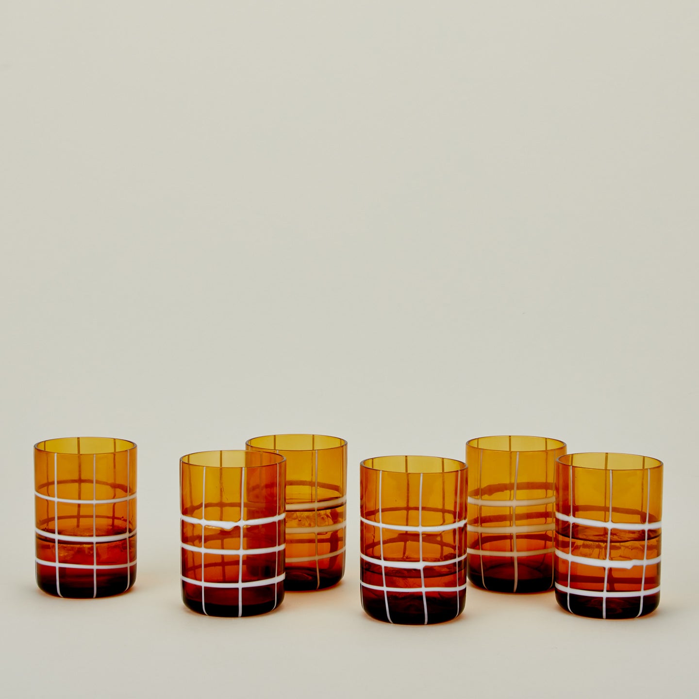 Set of 6 Twiddle Tumblers in Amber with water.