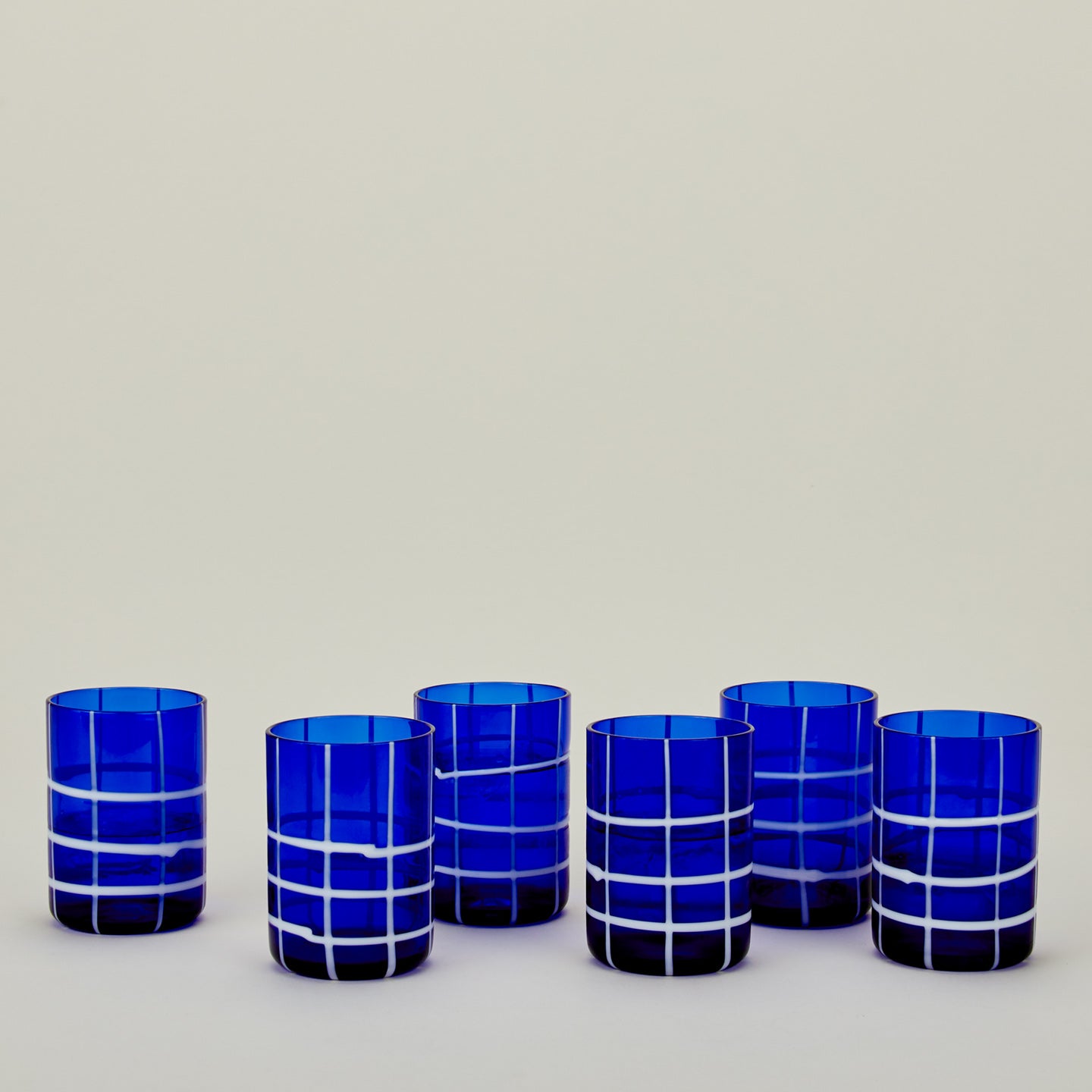 Set of 6 Twiddle Tumblers in Cobalt with water.