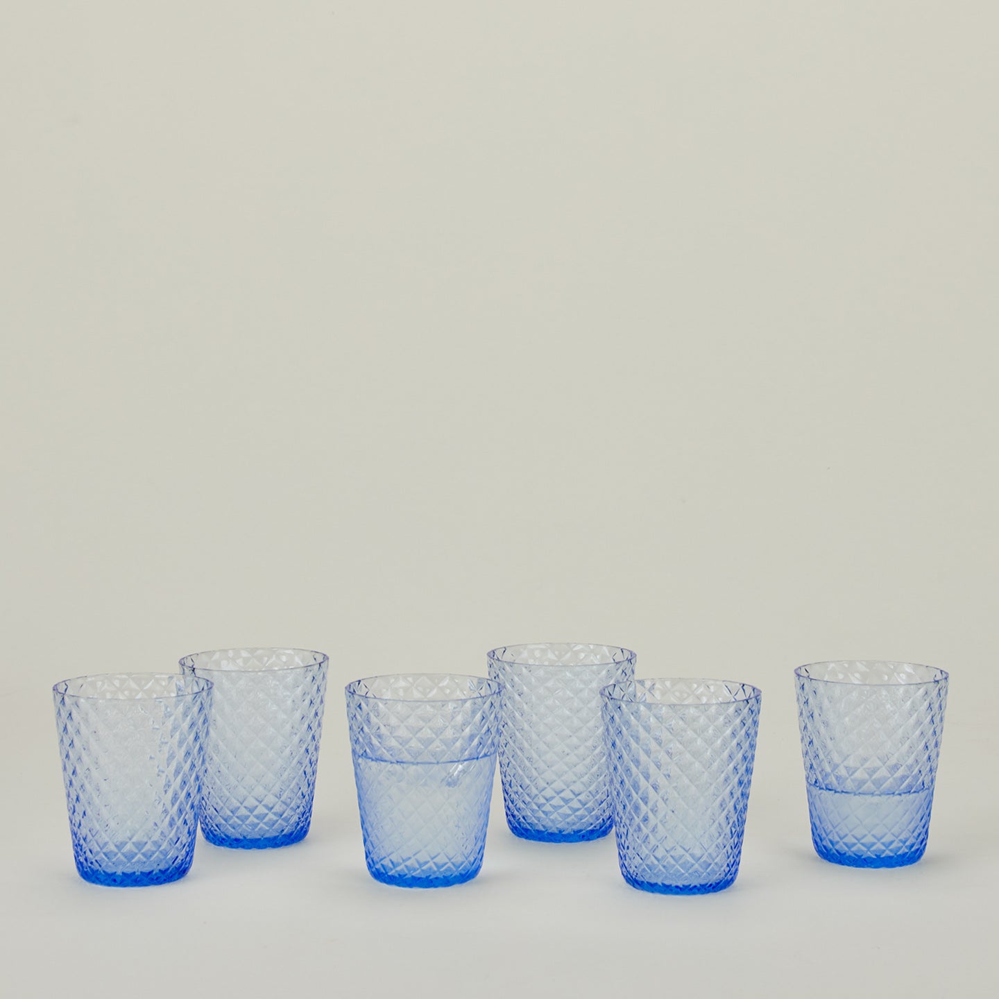 Set of 6 Veneziano Tumblers in Light Blue, with water.