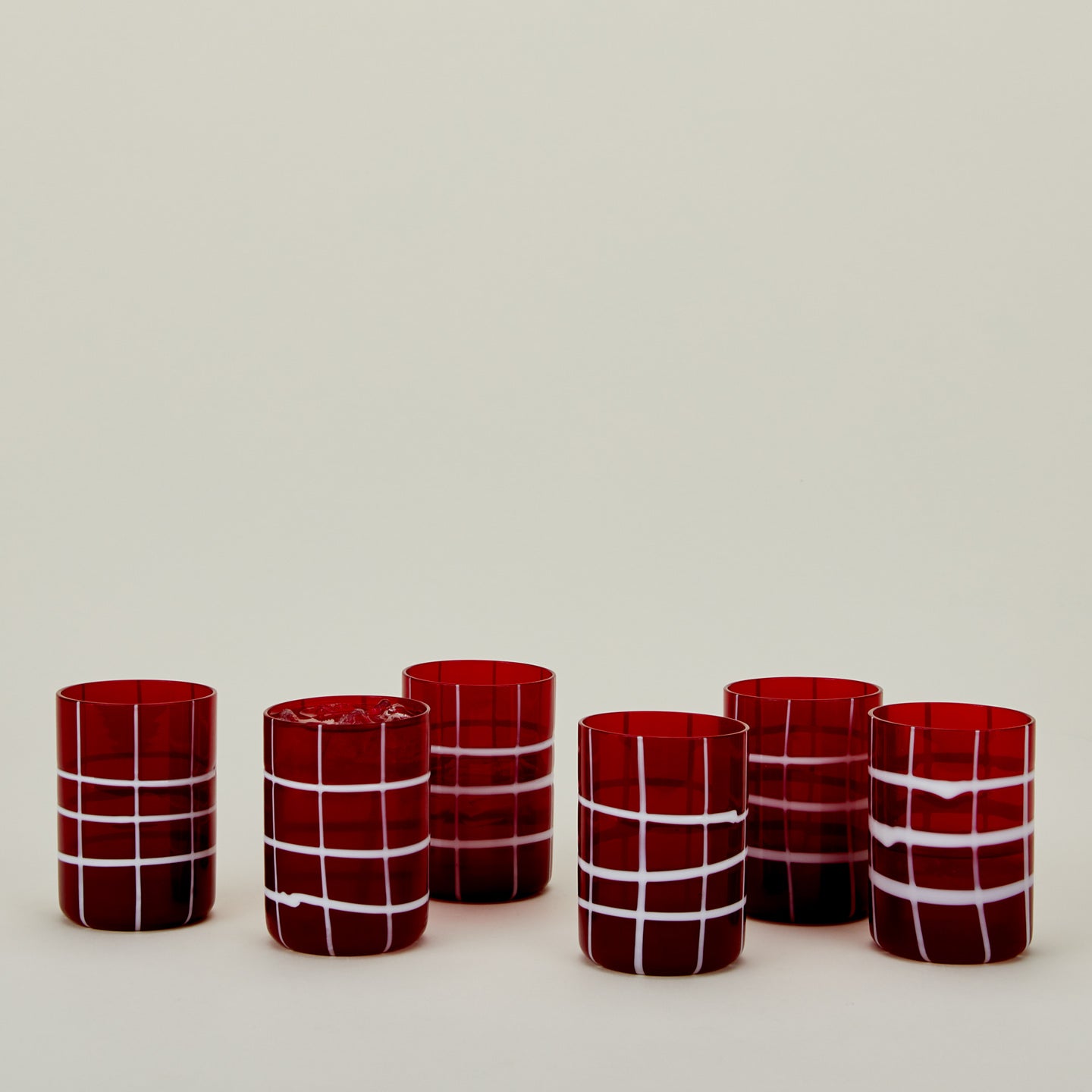 Set of 6 Twiddle Tumblers in Red with water.