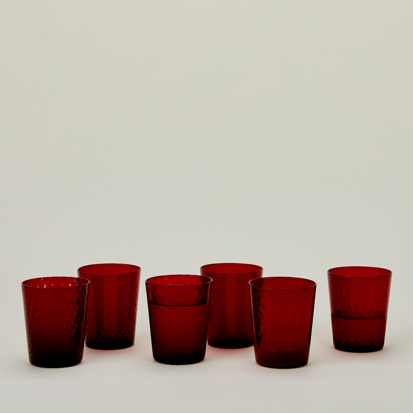 Set of 6 Veneziano Tumblers in Red, with water.