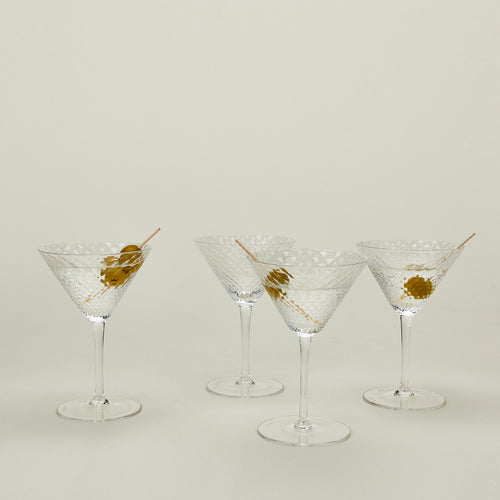 Four Veneziano martini glasses with martinis.