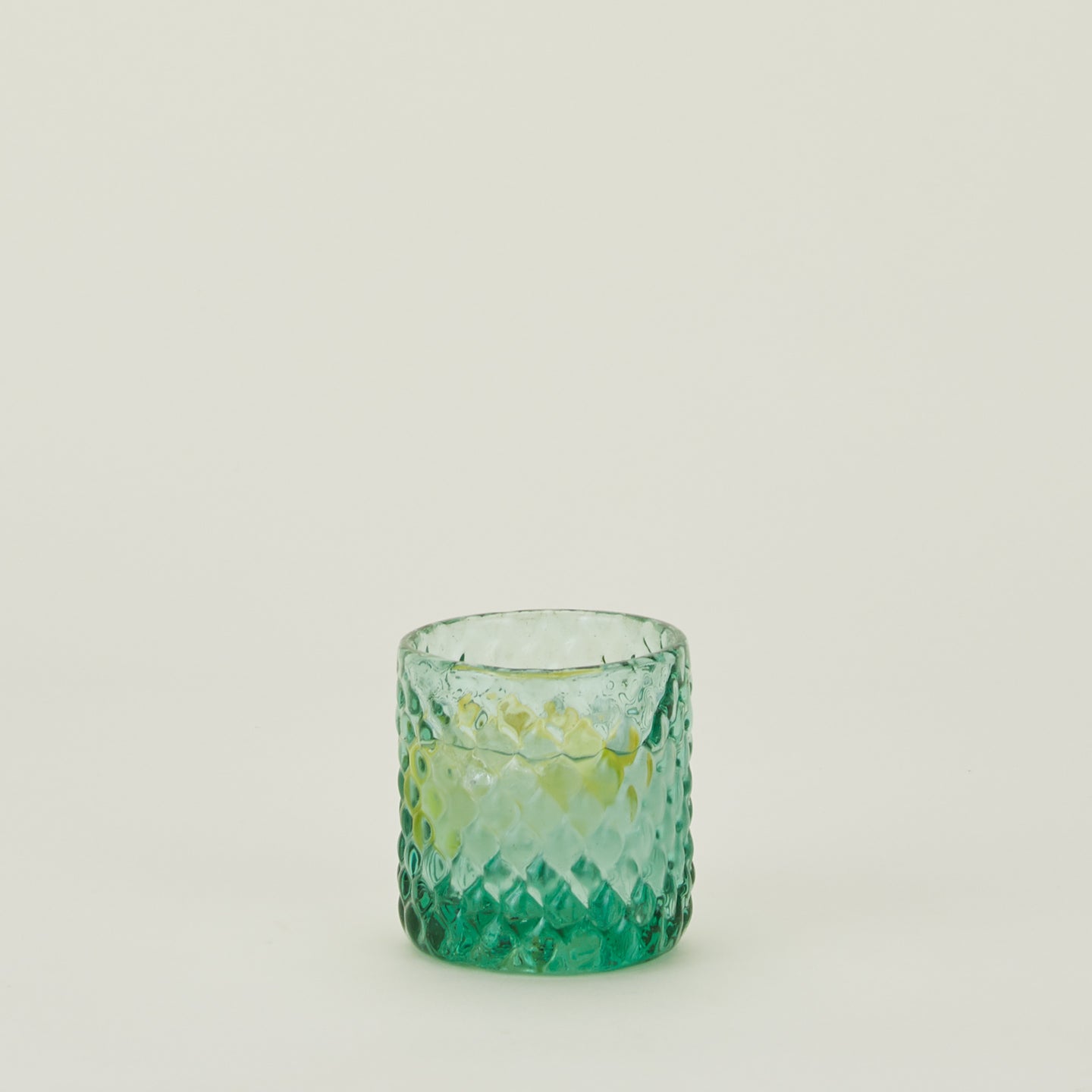 Green glass Recycled Textured Tumbler filled with water and lemon.