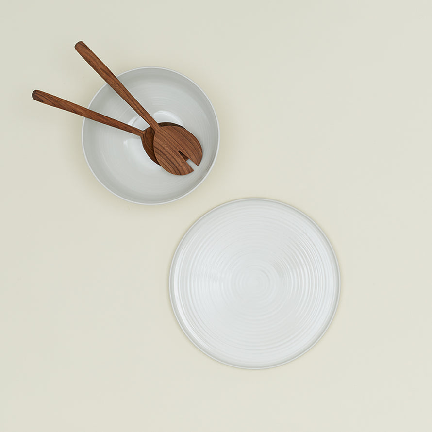 Essential Serving Bowl and Serving Platter in Bone, with wood serving utensils.